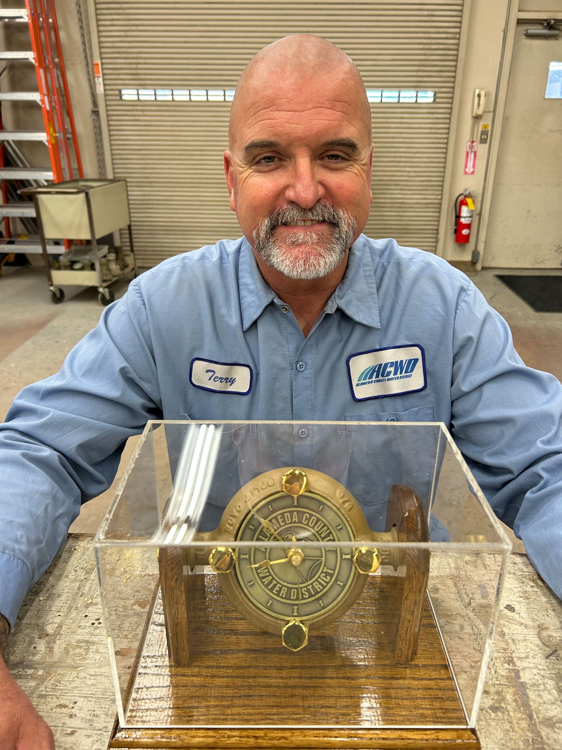 Picture of Terry L., facilities maintenance worker with a meter clock