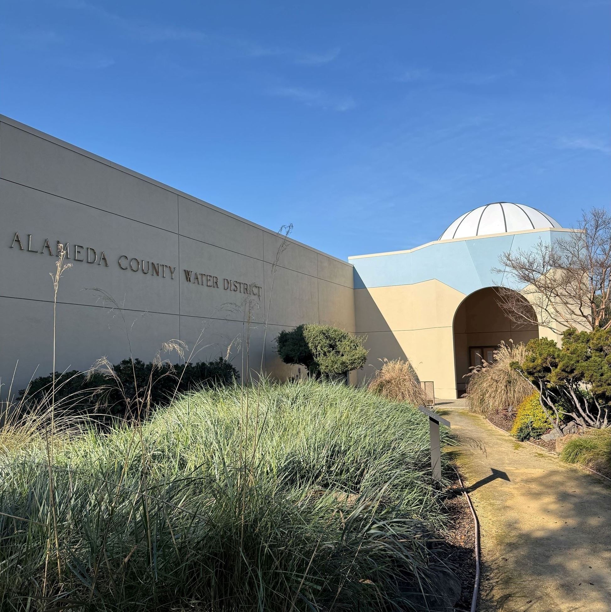 ACWD headquarters building, featuring the main entrance and adjacent drought-tolerant garden
